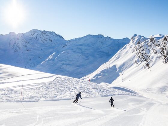 meribel snowy alps with skiiers in background