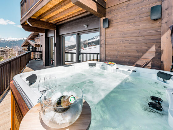 Jacuzzi on the terrace of Chalet Bacchus, in the sunlight.
